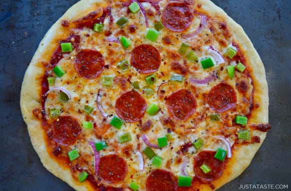 A homemade pizza on top of a metal baking sheet