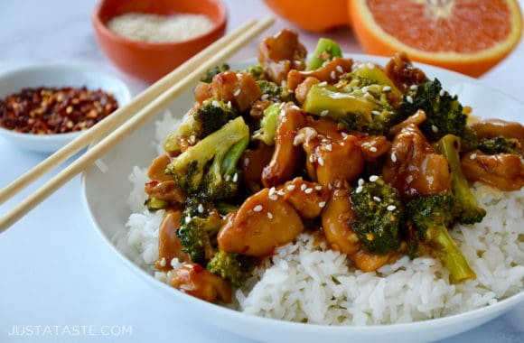 Bowl with chopsticks containing the best Quick Orange Chicken and Broccoli over white rice