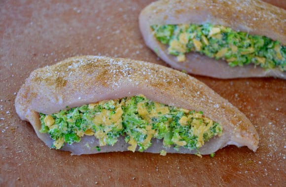 Raw chicken breasts stuffed with broccoli and cheddar cheese