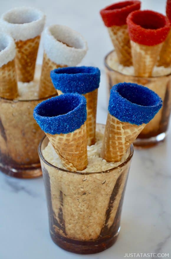 Red, white and blue ice cream cones drying in cups filled with rice