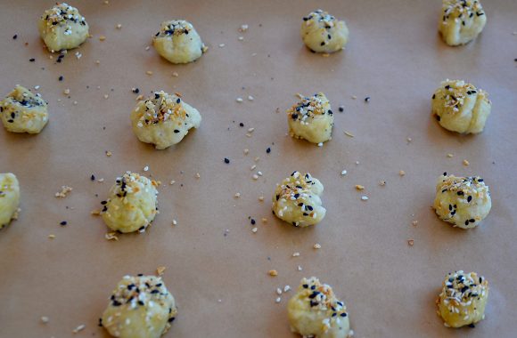 A baking sheet containing unbaked soft pretzels