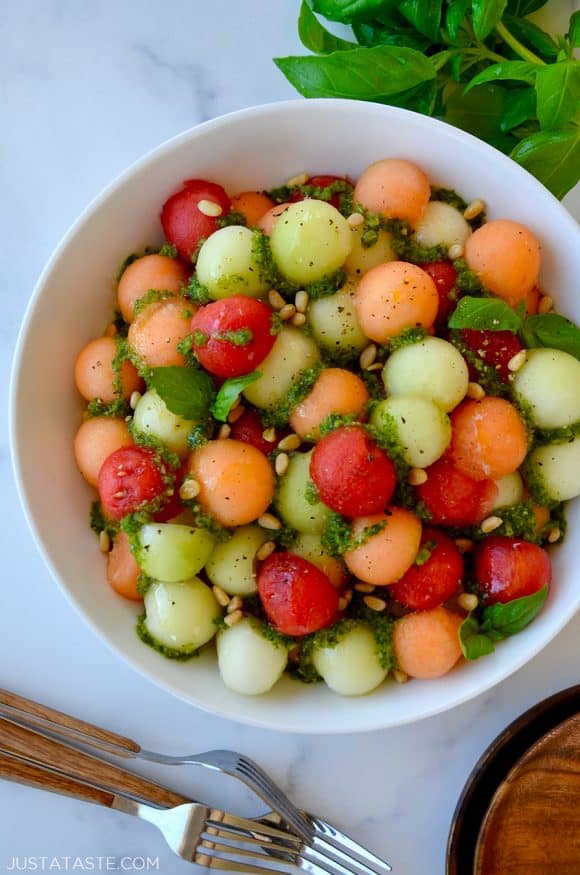 Top down view of white bowl containing easy melon salad with basil vinaigrette