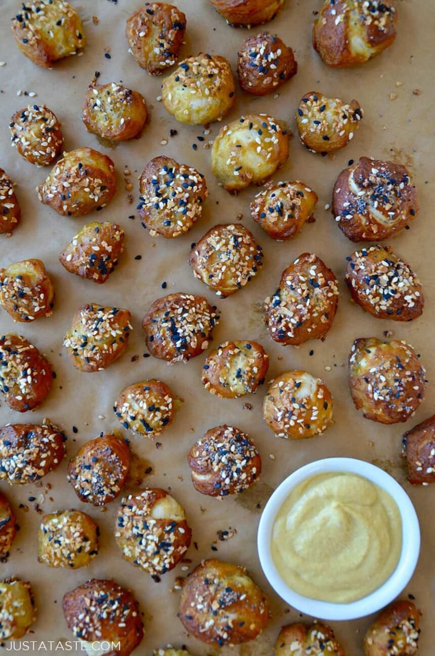 Brown parchment paper with soft pretzel bites topped with everything seasoning