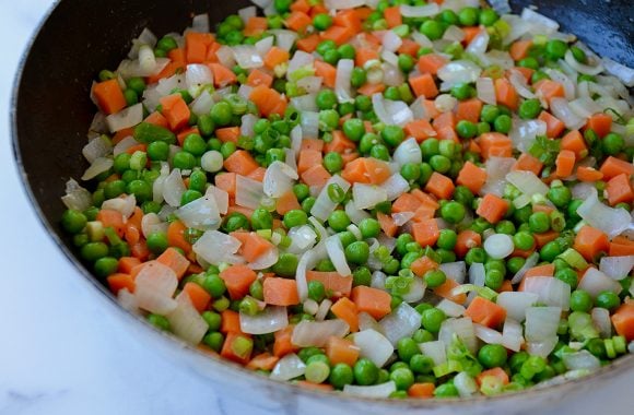 Peas, carrots and onions in large skillet
