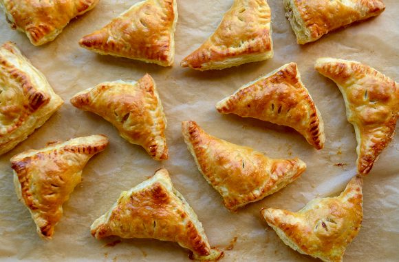 Freshly baked turnovers on brown parchment paper