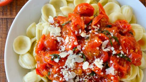 Top down view of quick cherry tomato pasta sauce over orecchiette