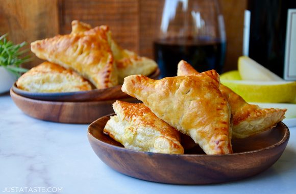 The best fruit and cheese turnovers on wood plates with wine in background