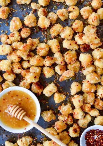 Baked Popcorn Chicken with Honey-Garlic Glaze topped with crushed red pepper flakes