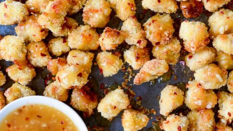 Baked Popcorn Chicken with Honey-Garlic Glaze topped with crushed red pepper flakes