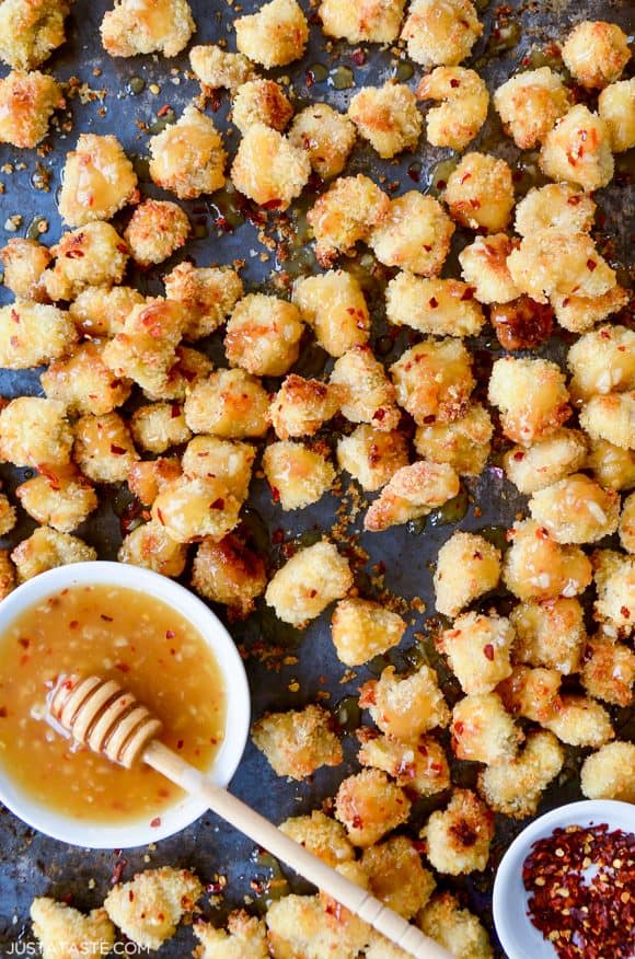 Baked Popcorn Chicken with Honey-Garlic Glaze topped with crushed red pepper flakes