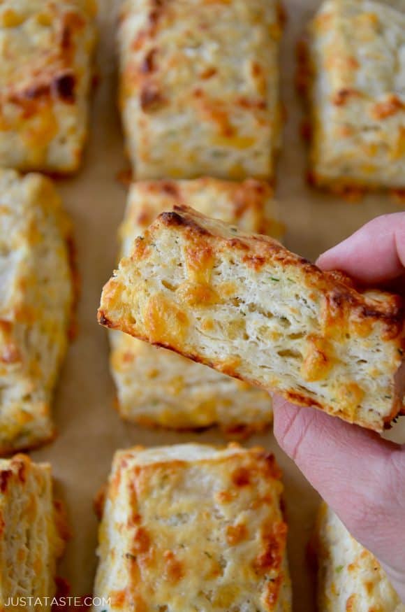 Hand holding easy cheddar biscuits with flaky layers