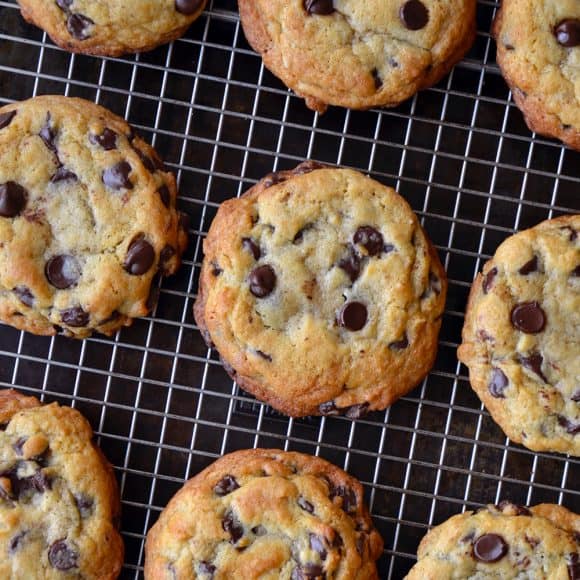 A cooling rack containing chocolate chip cookies