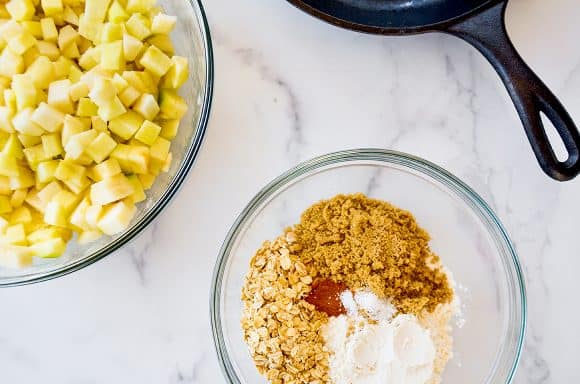 Bowls containing crisp ingredients and diced fruit