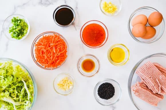 Various sized bowls containing egg roll ingredients