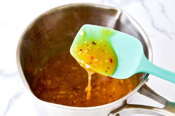 Spatula over pan with honey-garlic glaze