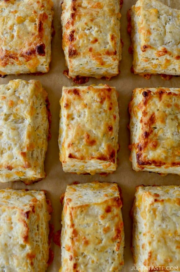 Rows of The Best Cheddar Biscuits on parchment paper-lined baking sheet