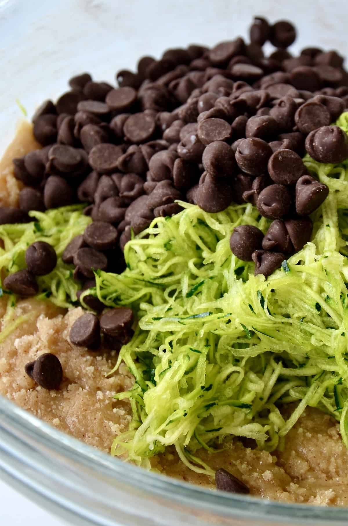 Bread batter topped with finely shredded zucchini and chocolate chips.