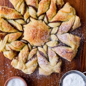 A top-down view of a puff pastry dessert dusted with confectioners' sugar