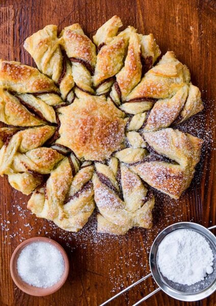 A top-down view of a puff pastry dessert dusted with confectioners' sugar