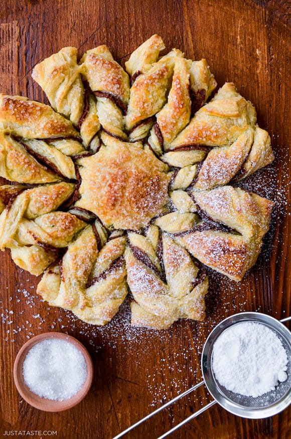 A top-down view of a puff pastry dessert dusted with confectioners' sugar