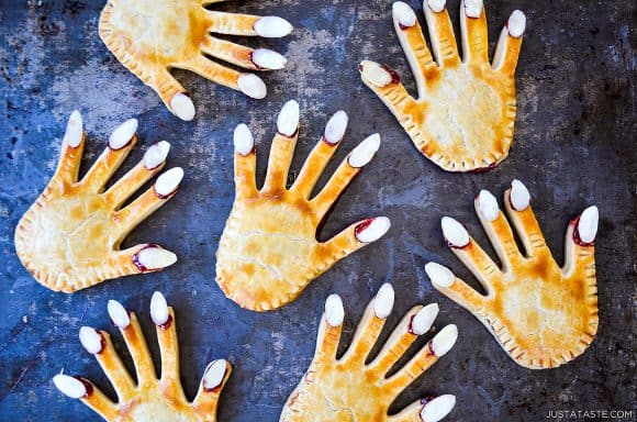 Easy Halloween Hand Pies with almonds for nails on blue surface