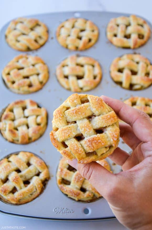 Hand holding easy muffin tin mini apple pie with lattice pie crust