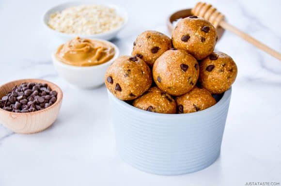 Easy No-Bake Peanut Butter Protein Balls studded with chocolate chips piled high in a bowl 