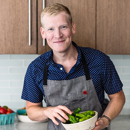 Justin Chapple holding a bowl of shishito peppers