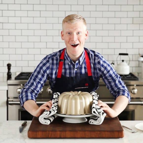 Justin Chapple holding a bundt cake pan for Mad Genius Tips