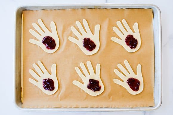 Dough filled with jam on baking sheet