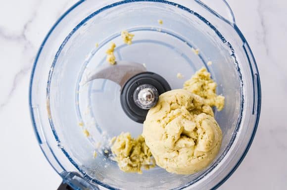 Top down view of food processor with dough