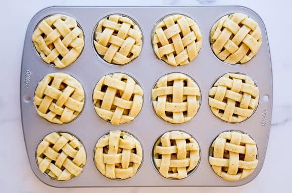 Muffin tin apple pies topped with weaved pie dough