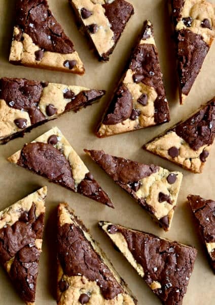 Brookies (chocolate chip cookie brownies) cut into triangles and topped with large flake sea salt.