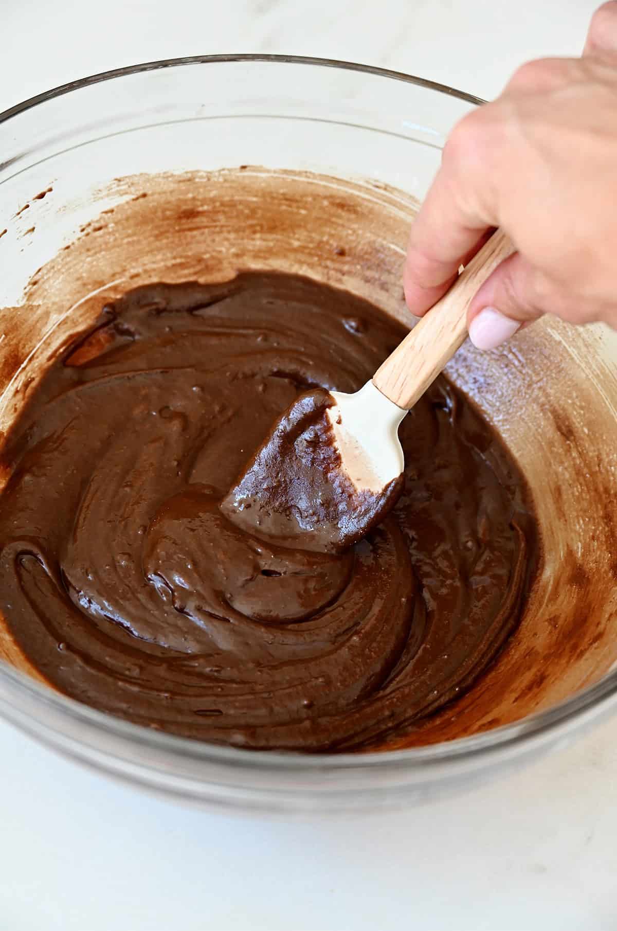 Brownie batter for brookies in a bowl with a spatula.