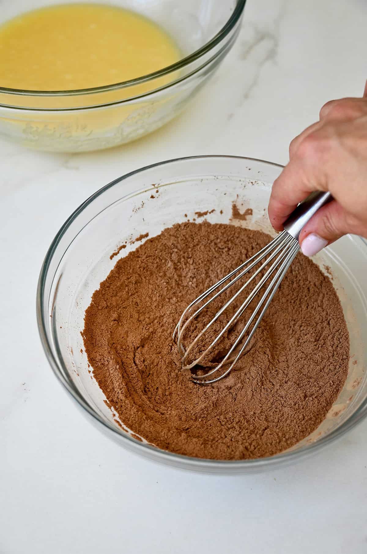 Dry ingredients for brownies whisked together in a bowl.
