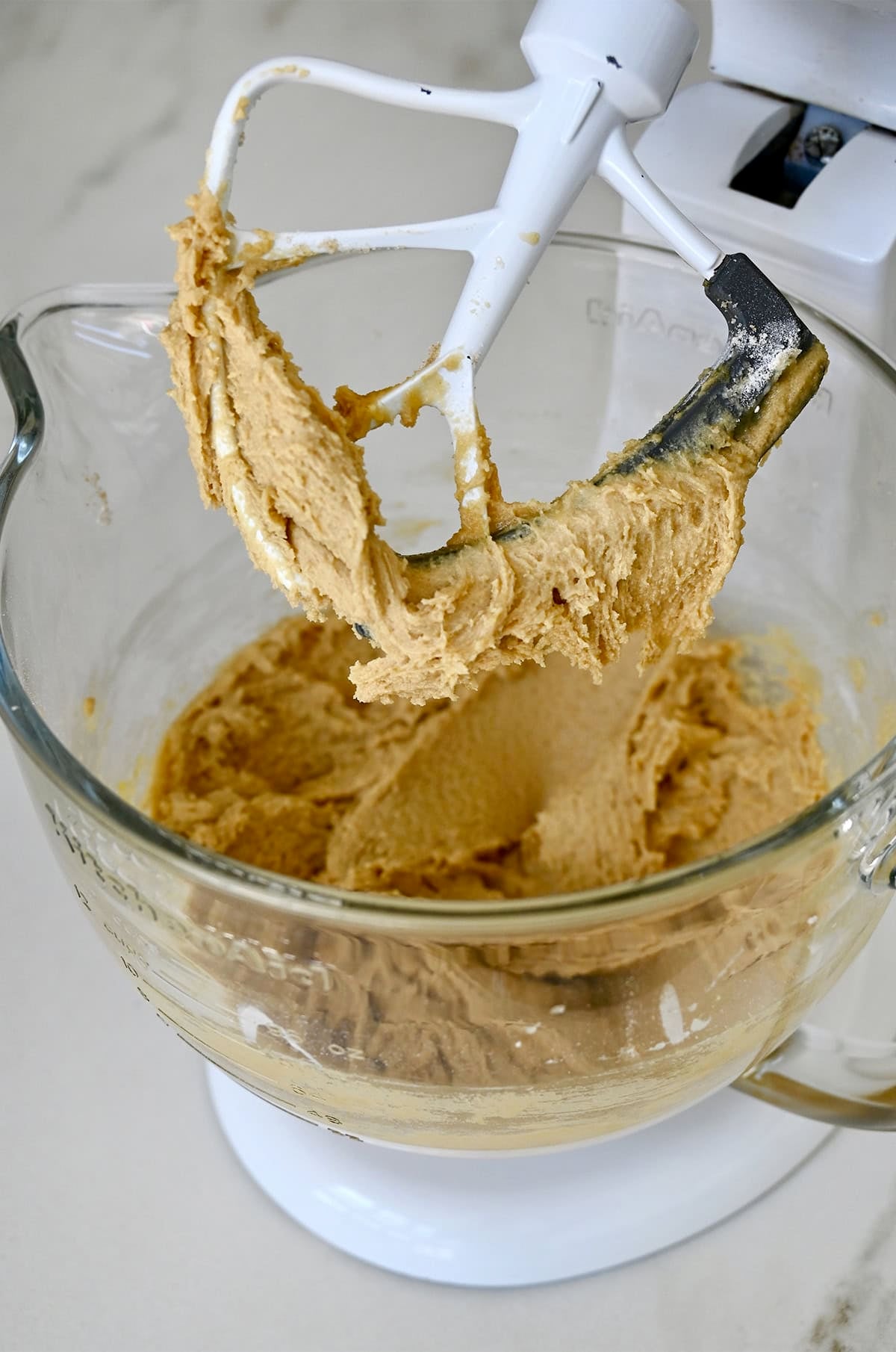 Cream butter and sugar in a stand mixer bowl with the paddle attachment.