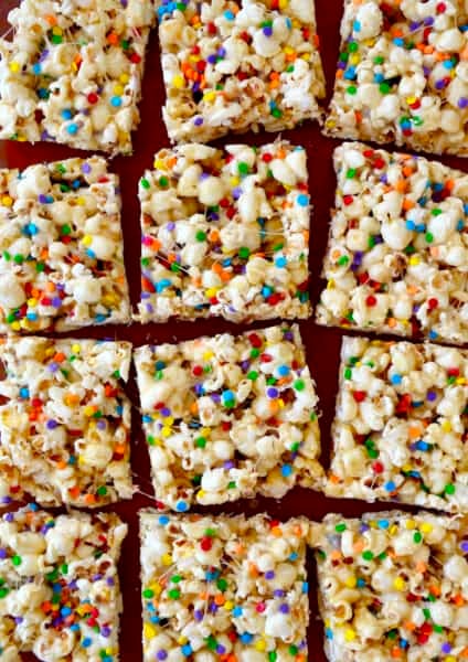 Squares of Funfetti Marshmallow Popcorn Treats.