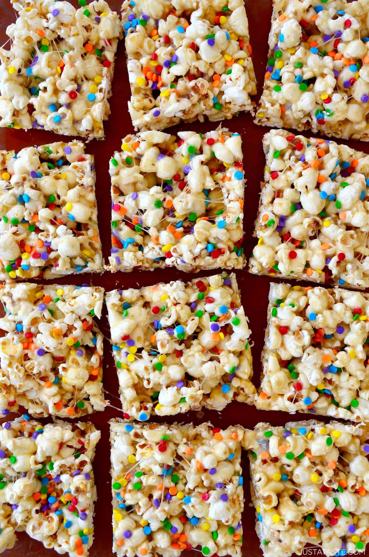 Squares of Funfetti Marshmallow Popcorn Treats.