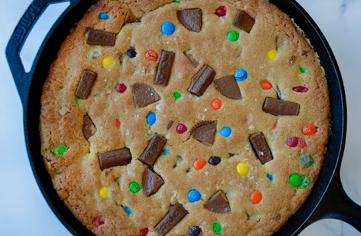 Freshly baked skillet cookie studded with chopped Reese's Peanut Butter Cups, Kit-Kat bars and M&Ms.