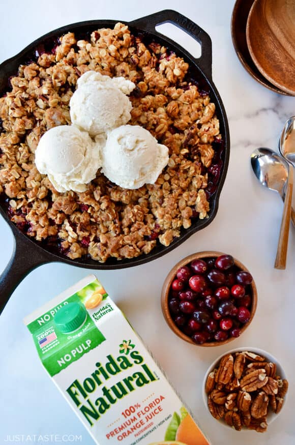 A skillet containing cranberries and a crisp topping with ice cream