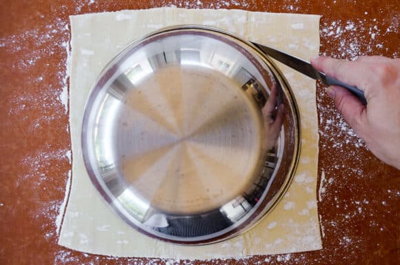 A bowl atop a sheet of puff pastry