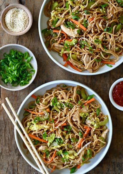 A top-down view of two bowls containing Quick Chicken Chow Mein and chopsticks