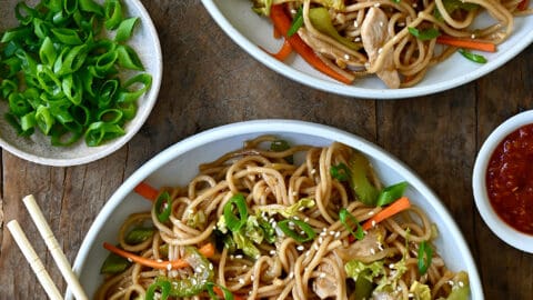 A top-down view of two bowls containing Quick Chicken Chow Mein and chopsticks