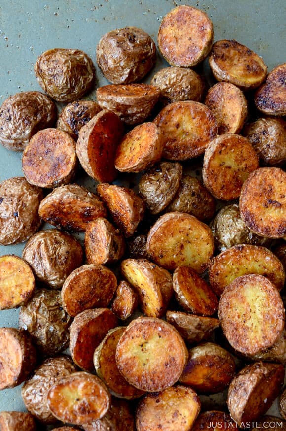 A close-up of roasted potatoes on a baking sheet
