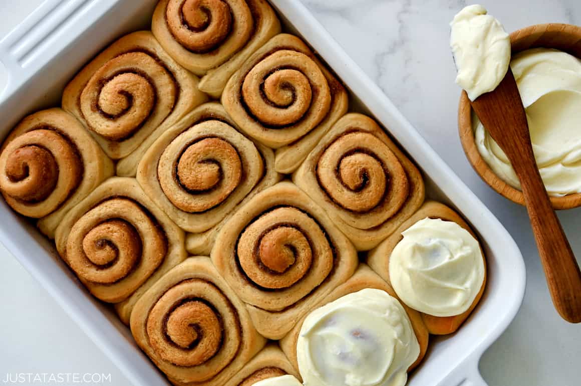 Homemade Cinnamon Rolls topped with cream cheese frosting in a white baking dish