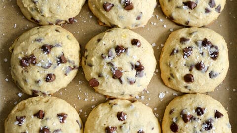 A top-down view of Banana Chocolate Chip Cookies on a parchment paper-lined baking sheet