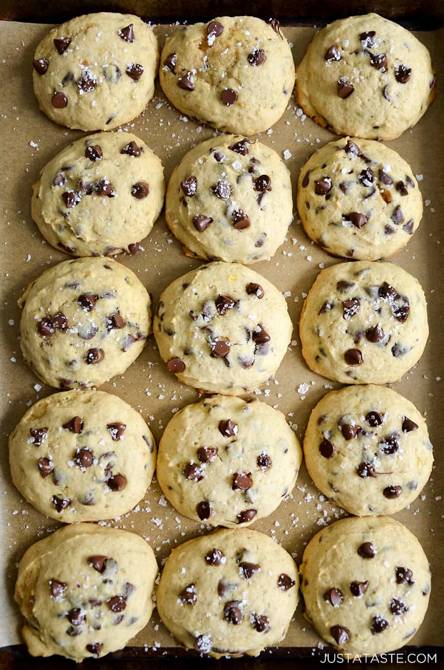 A top-down view of Banana Chocolate Chip Cookies on a parchment paper-lined baking sheet