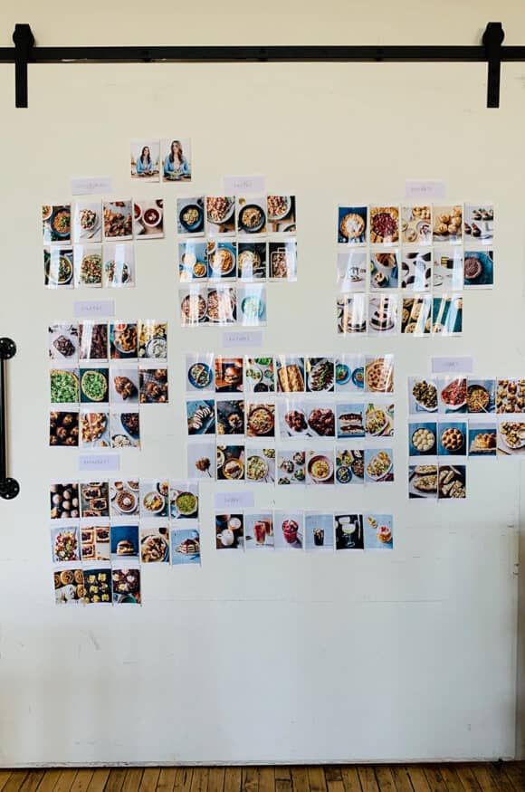 A white wall containing all of the photos from The Secret Ingredient Cookbook photo shoot