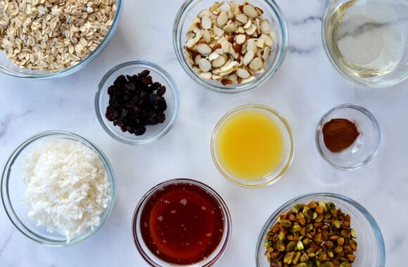 Glass bowls containing the ingredients for homemade granola