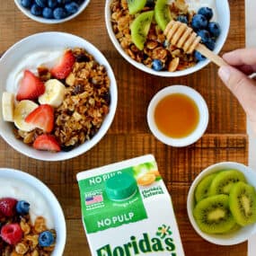 A top-down view of granola parfaits with fruit and yogurt